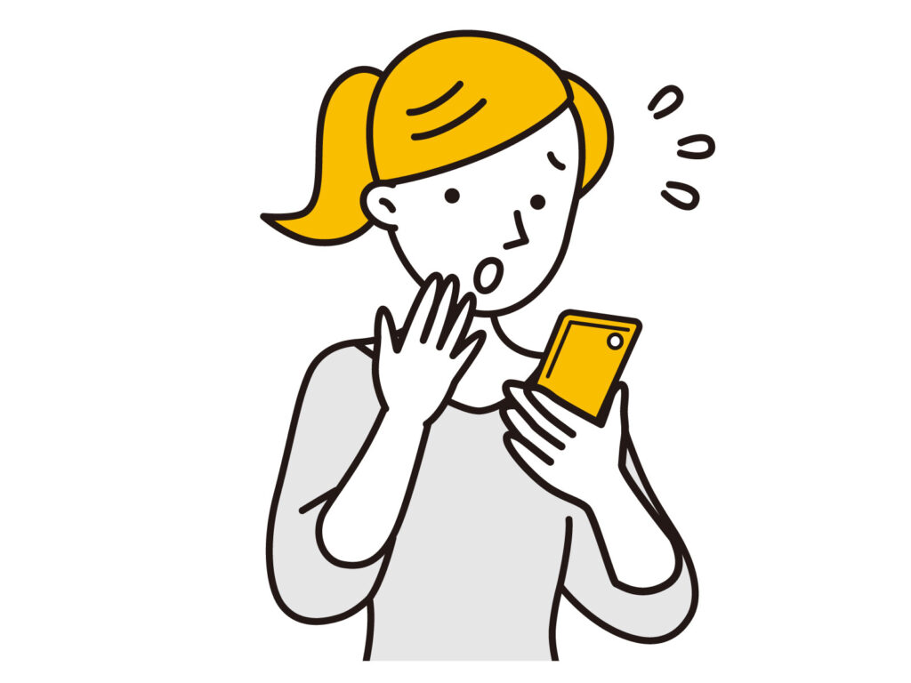 スマホを見て焦る女性
