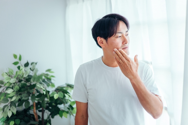 ほほの滑りを確認する男性